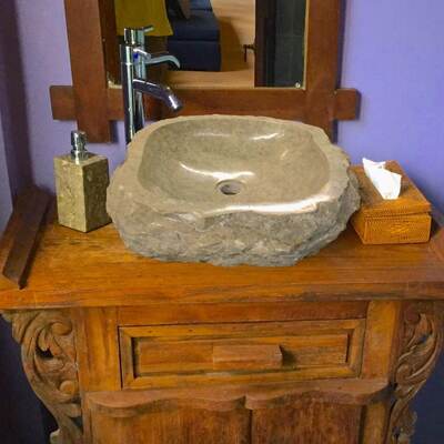 Stone vessel sink on carved vanity