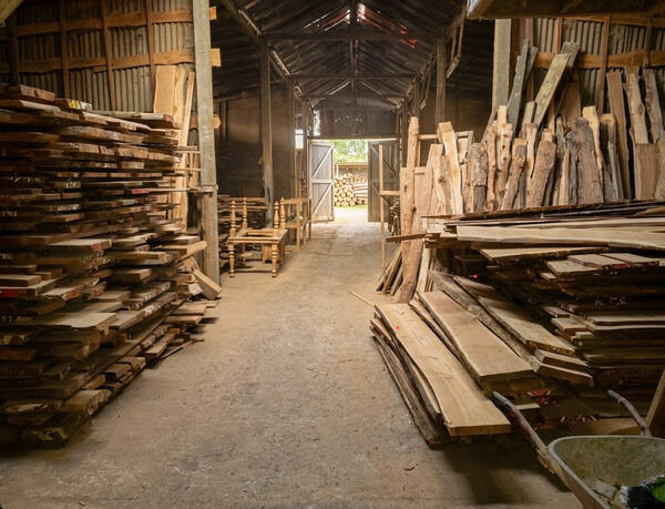 Timber warehouse with stacked hardwood planks